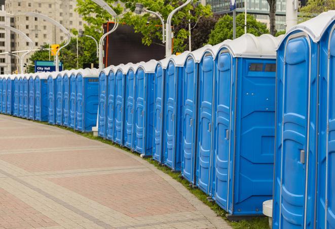 a line of portable restrooms at an outdoor wedding, catering to guests with style and comfort in Carthage, TX